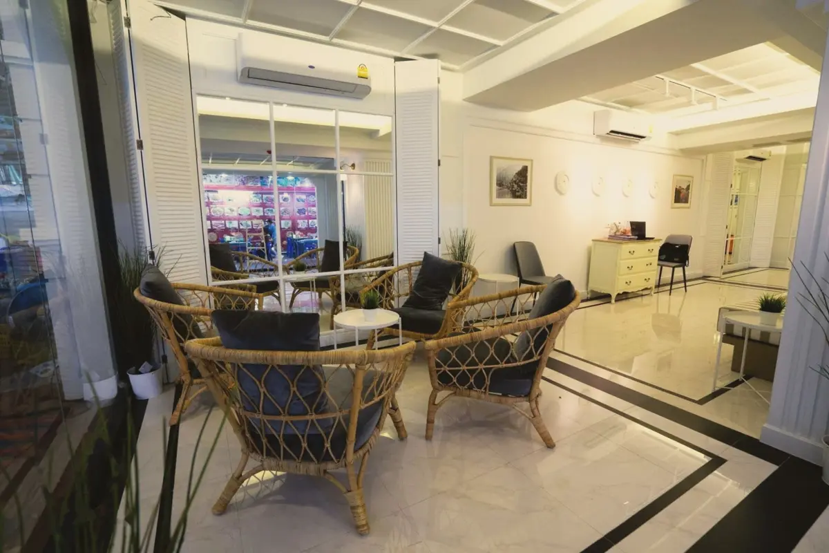 Lobby lounge with rattan armchairs and marble floor