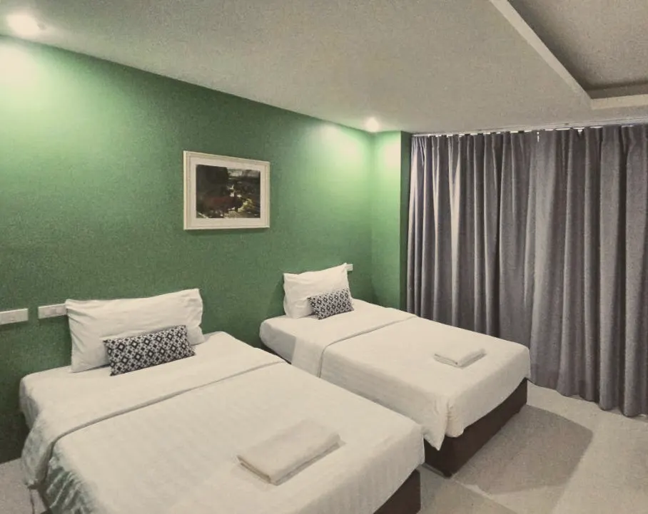 Twin room with two single beds and full-length curtains